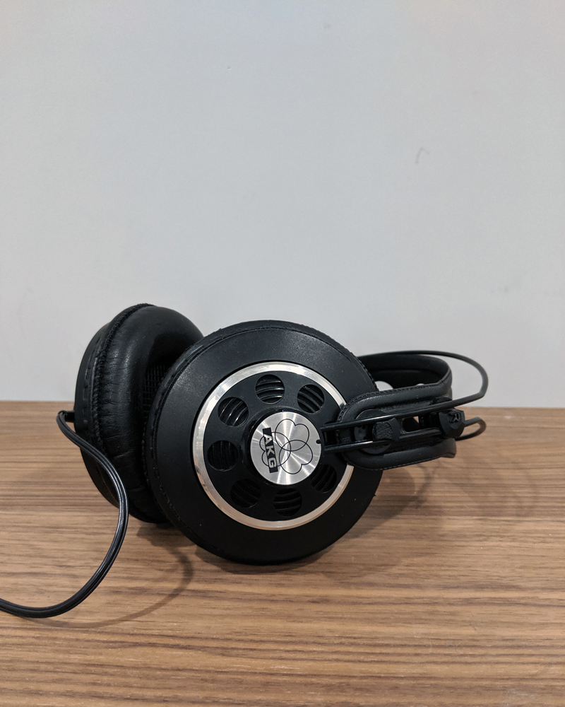 AKG headphones on wood table.